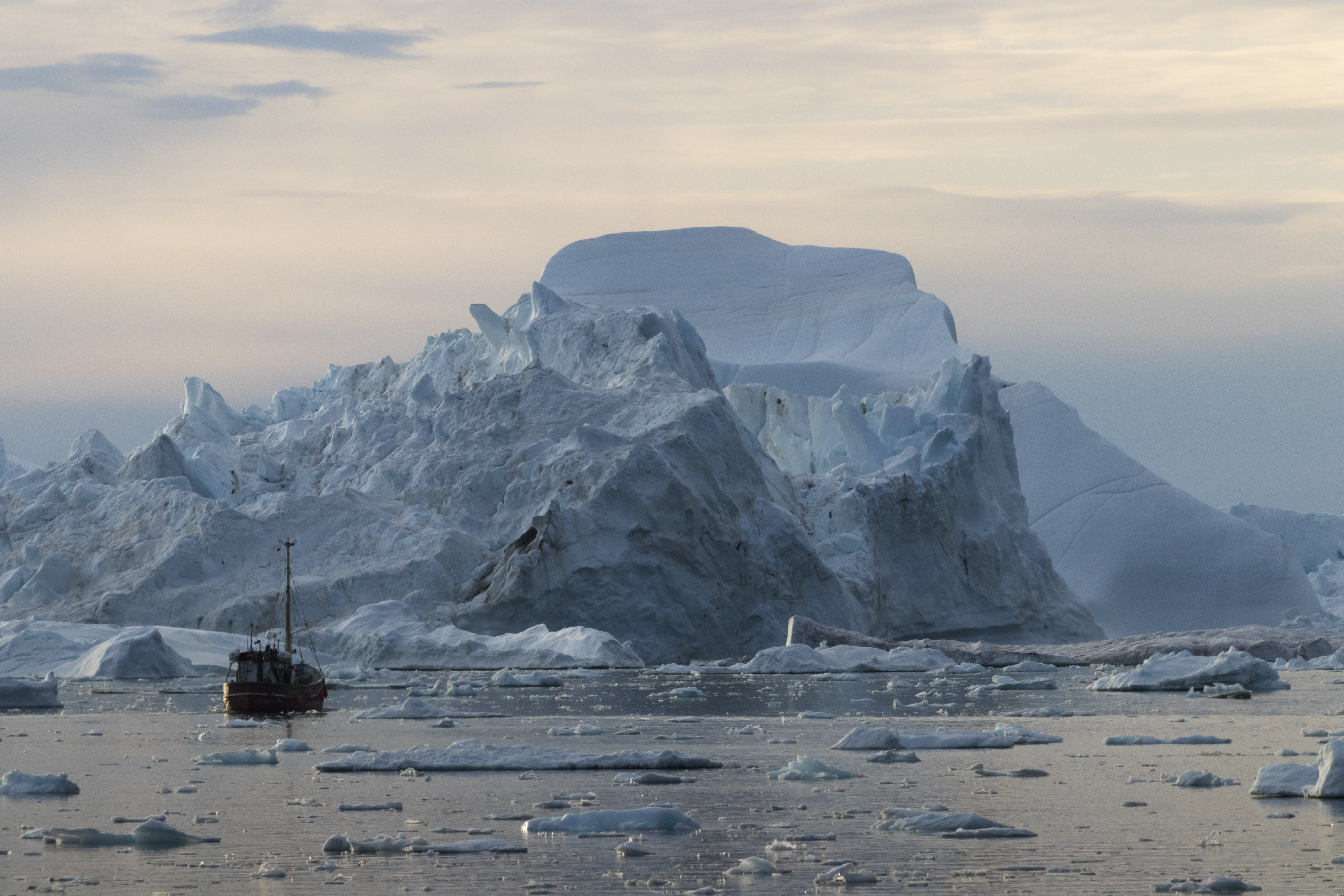 Icebergs and a boat in Disko Bay, Greenland
